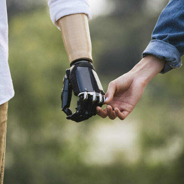 man with prosthetic hand holds a woman's hand - deposit photos